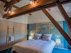 a bedroom with a bed with blue walls and a ladder at Gite le Nourrissat in Esclottes +35 photos