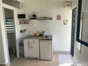 a small kitchen with a sink and a stove at Paradise in Baie-Mahault