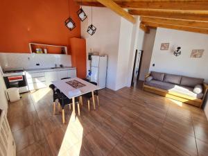 a kitchen and living room with a table and a couch at Del Sendero Caviahue in Caviahue