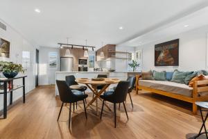 a kitchen and living room with a table and chairs at Wanaka Station Apartment in Wanaka