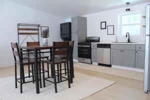 a kitchen with a table and two chairs and a stove at The Lake Barndominium in Delton