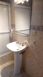 a bathroom with a white sink and a mirror at Casa 3 Hab con 2 cocheras Centro in Mendoza