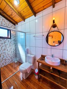 a bathroom with a toilet and a sink at Cabanas Colina Do Sol in Cambará +36 photos