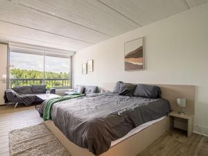 a bedroom with a large bed and a large window at Delightful 1BR Condo Next to Disney With Lake view in Vineland +30 photos
