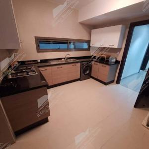a large kitchen with a sink and a stove at Lemon Grove Villa Taghazout Bay Amda in Taghazout