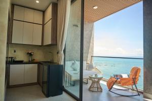 a kitchen and living room with a view of the ocean at Memory Beach Hotel Phú Quý in Cu Lao Thu