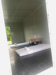 a room with a large white bed and a table at The Waves at Socorro Baler- Hotel A in Reserva
