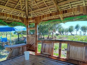 a porch of a resort with a table and chairs at The Waves at Socorro Baler- Hotel A in Reserva