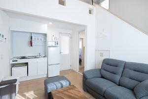 可儿市A home Happytown6的带蓝色沙发的客厅和厨房