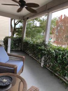 a screened porch with a couch and a ceiling fan at Habersham Hideaway in Savannah