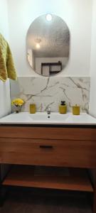 a bathroom with a sink and a mirror at Sonqo Andino Departamento in Cusco +11 photos