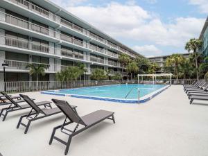 a swimming pool in front of a large building at Elegant 1BR Haven in Orlando & 5 minutes to Disney in Vineland