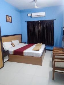 Ένα ή περισσότερα κρεβάτια σε δωμάτιο στο JK Residency