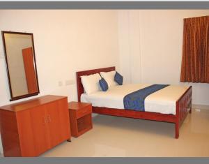 Ένα ή περισσότερα κρεβάτια σε δωμάτιο στο JK Residency