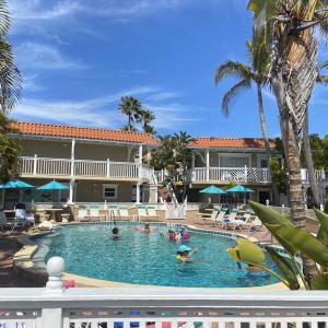 a pool at a resort with people in it at Tortuga Inn Beach Resort Unit #229 in Bradenton Beach