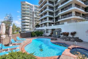 a swimming pool in front of a apartment building at Chateau Royale Unit 36 in Gold Coast