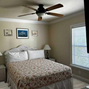 a bedroom with a bed with a ceiling fan at Tortuga Inn Beach Resort Unit #229 in Bradenton Beach +27 photos