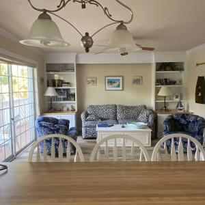 a living room with a couch and two chairs at Tortuga Inn Beach Resort Unit #229 in Bradenton Beach