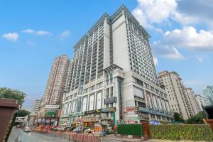 a large white building on a city street at Echarm Hotel Guangzhou East Railway Station South China Normal University Metro Station in Guangzhou