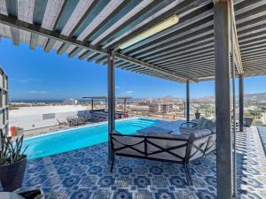 a patio with a bed and a swimming pool at Cabo 16 in Cabo San Lucas