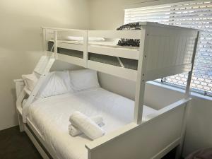 a white bunk bed in a room with a window at Camelot Unit 12 in Forster