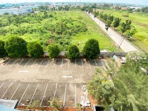 an aerial view of a parking lot with trees at Homey and Simply Studio The Enviro Apartment By Travelio in Cikarang