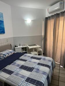 a hospital room with a bed and a table at Pier Sul Apart Service in Salvador