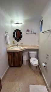 a bathroom with a sink and a toilet at Blue angel 20 a pasos de la 5 av in Playa del Carmen +12 photos