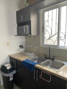 a kitchen with a sink and a window at bonita casa cerca de la Alameda in Saltillo