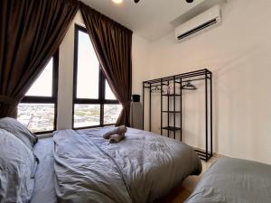 a bedroom with a bed with a teddy bear on it at Next to BRT station near Sun-Med Sun-Uni & Lagoon in Kampong Penaga +27 photos