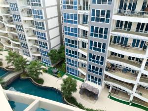 an aerial view of two tall apartment buildings with a pool at Centara Avenue Residence By Daisy Pattaya 1 in Pattaya Central