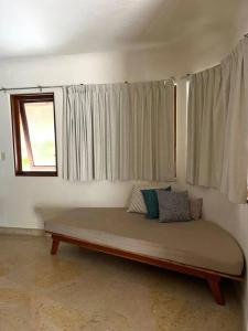 a large bed in a room with a window at blue angel 22 a unos paso de la 5v y la playa in Playa del Carmen +21 photos
