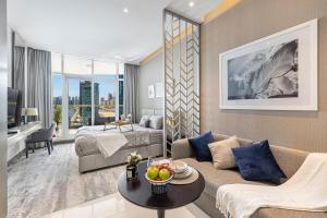 a living room with a couch and a bed at Livin' Holidays - Luxury studio with Bay view in Dubai