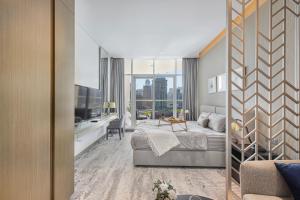 a hotel room with a bed and a large window at Livin' Holidays - Luxury studio with Bay view in Dubai +37 photos