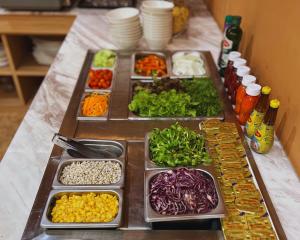 a table with several trays of different types of vegetables at Villa Sirilanna Hotel in Chiang Mai