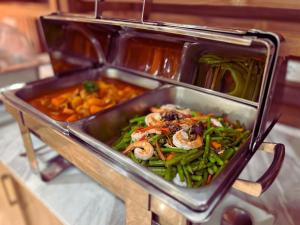 a tray of food with seafood and vegetables on a table at Villa Sirilanna Hotel in Chiang Mai