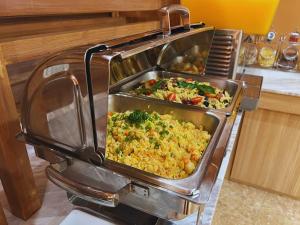 a buffet of food in an oven in a kitchen at Villa Sirilanna Hotel in Chiang Mai