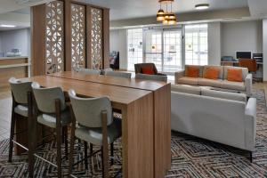 a conference room with a table and chairs at Candlewood Suites Kansas City Northeast by IHG in Kansas City +76 photos