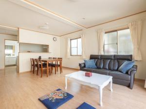 a living room with a couch and a table at Dryokan Kumanocho in Tokyo