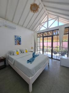 a bedroom with a bed with a blue towel on it at Coco Colada Bungalows in Kuta Lombok