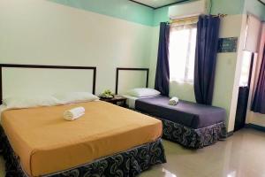 Postel nebo postele na pokoji v ubytování EC Hotel near Laoag Airport