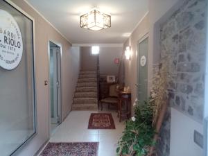a hallway with a staircase with rugs at BARDI AL RIOLO Robinia Apt in Bardi