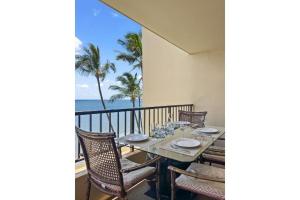 a table on a balcony with a view of the ocean at SUGAR BEACH RESORT, #540 condo in Kihei