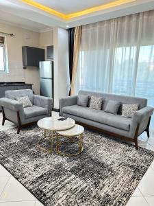 a living room with a couch and a table at LivLuxe Apartments 3 in Bulambiro