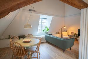 a living room with a table and a couch at Amersfoort City Center Apartment StadsHart in Amersfoort
