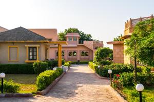 a house with a brick driveway in front of it at Thar Oasis Resort and Camp in Dechu