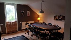 a room with a table and chairs and a window at Blackwood Villa in Hålahult