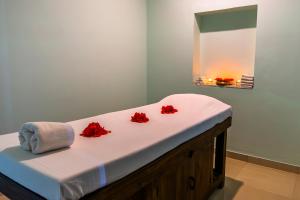 a bed in a room with red flowers on it at Thar Oasis Resort and Camp in Dechu