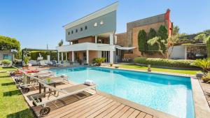 a house with a swimming pool and a building at VILLA TIBERIO 6&2, Emma Villas in Genzano di Roma