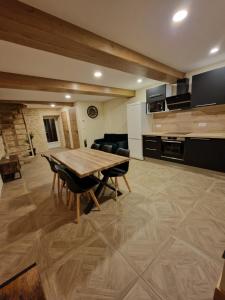 a living room with a wooden table and chairs at Charmante maison de ville in Châtillon-sur-Seine +3 photos